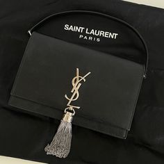 Ysl Saint Laurent Kate Tassel Crossbody Wallet In Excellent Condition, Minimal Wear, Only Flaw A Few Tassel Strands Are Short But Not Noticeable Includes Dust Bag Kate Chain Wallet In Grain De Poudre Leather Evening Purse In Calfskin Leather With Chain Strap And Iconic Saint Laurent Tassel. This Elegant Accessory Can Be Carried In The Hand As A Clutch Or On The Shoulder Using Its Detachable Chain. Chrome And Metal-Free Tanned Leather Silver-Toned Brass Hardware Magnetic Snap Tab Six Card Slots B Ysl Saint Laurent, Yves Saint Laurent Bags, Chain Wallet, Evening Purse, Saint Laurent Paris, Crossbody Wallet, Elegant Accessories, Wallet Chain, Leather Silver