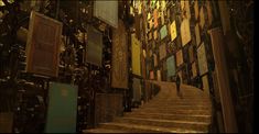 the stairs are made of wood and have many stained glass panels on each wall above them