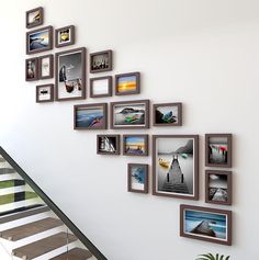 a stair case with many pictures on the wall