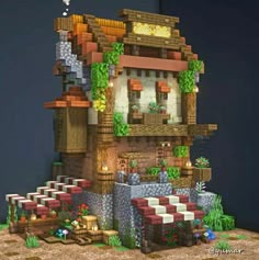 an image of a house made out of lego blocks and bricks with plants growing on the roof