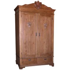 an old wooden armoire with carvings on the top and bottom panel, against a white background