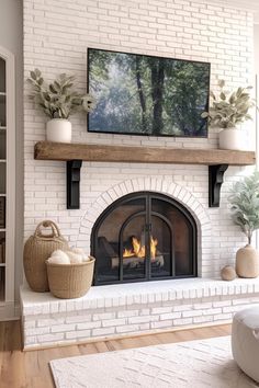 a living room with a fire place and tv on the wall above it's mantle