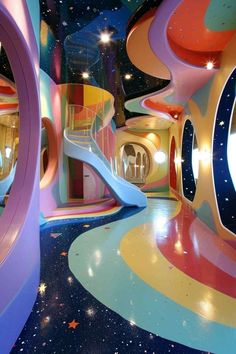 the interior of a colorfully decorated building with stairs and spiral staircases in it