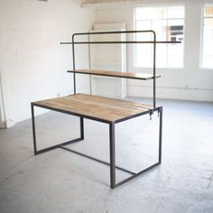 an empty room with a table and shelves