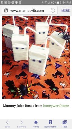 four plastic containers sitting on top of an orange tablecloth with spider crawling around them