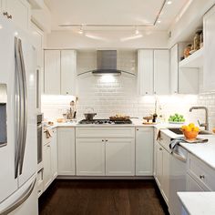 the kitchen is clean and ready for us to use it's white cabinetry