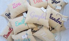 a pile of pillows with names on them