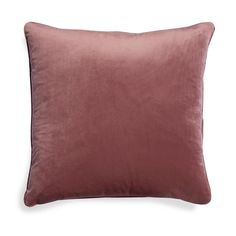 a dark pink velvet pillow on a white background