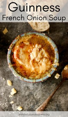 a bowl filled with soup next to bread on top of a stone table and text overlay reads guinness french onion soup