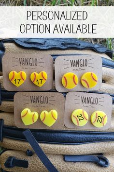 three yellow softball buttons sitting on top of a bag with the words, personalized option available