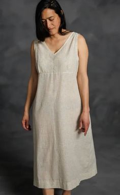 a woman in a white dress posing for the camera