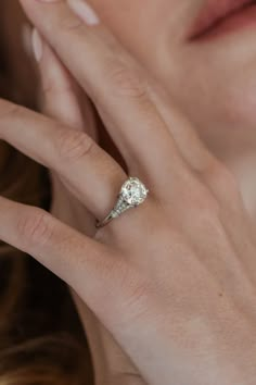 a close up of a person wearing a diamond ring