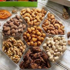 nuts and dried fruits in plastic containers on a table