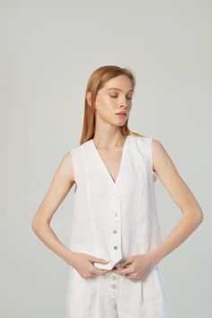 A perfect linen vest top could be a formal outfit and also free style. It depends on your own style, accessories, and occasion. This classic top suit for ladies who appreciates sophistication and minimalism. Made of natural linen of the highest quality and flawlessly cut, this thing is suitable for the wardrobe in trendy "old money" and "coastal grandmother" styles. Free cut, with folds 4 buttons made from seashells Length 50cm/20inches Raw armhole effect with backstitching Linen belt with raw edges included Color of the belt: sky blue Belt loops on the right side Sizes: XS, S, M, L, XL, XXL Custom sizes are available Made of 100% natural linen, Oeko-Tex certified, free of harmful chemicals. It keeps the temperature of the body + -4 degrees, these clothes are not hot in summer and not cold Fitted Linen Tank Top For Everyday, Chic Fitted Linen Tank Top, White Linen Sleeveless Vest, Classic White Tank Top For Spring, Elegant White Vest Top, Chic Summer Linen Vest, Elegant Linen Tank Top For Spring, Elegant Cotton Sleeveless Blouse Vest, Elegant White Linen Tank Top