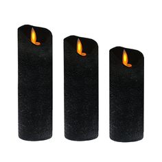 three black candles with yellow flame on them