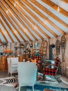 a living room filled with furniture and wooden beams