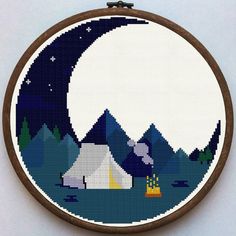 a cross stitch pattern with a camp site in the background