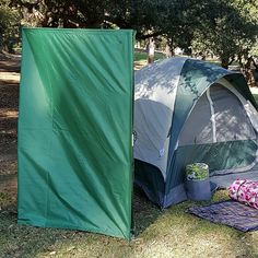 two tents are set up in the grass