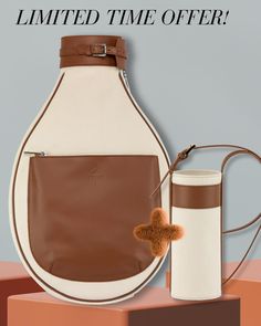 a brown and white purse next to a bottle with a pom - pom on it