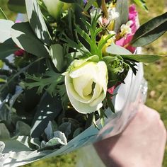 a person holding a bouquet of flowers in their hand