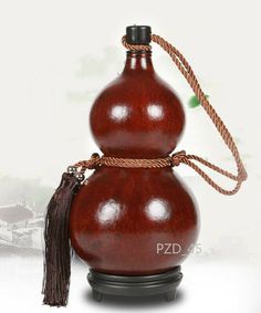 a wooden vase with a tassel on top