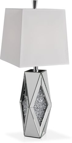 a table lamp with a white shade on it's base and a silver diamond design