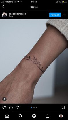 a person's wrist with a small tattoo on the left side of their arm