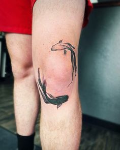 a man with a tattoo on his leg that has a fish in the middle of it