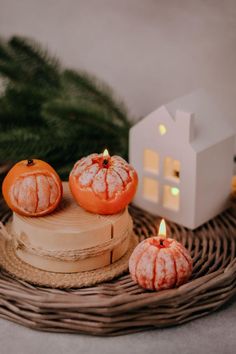 three small pumpkins sitting on top of a wicker tray