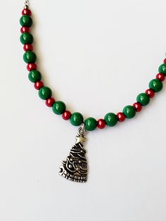 Silver Christmas tree charm with green glass and red pearl beads. I can adjust the length or add an extender upon request! Cheap Beaded Necklaces For Christmas, Christmas Beaded Necklace Ideas, Christmas Beaded Necklaces With Colorful Beads For Gift, Christmas Gift Beaded Necklaces With Colorful Beads, Christmas Holiday Necklace With Round Beads, Christmas Gift Colorful Beaded Necklaces, Christmas Gift Beaded Necklaces With Round Beads, Adjustable Round Beads Necklaces For Christmas, Adjustable Christmas Festive Necklaces