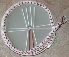 a white and red round object on the ground with strings attached to it's sides