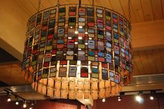 a chandelier hanging from the ceiling in a room with wood paneled walls