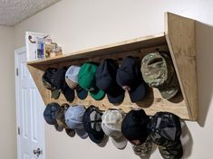 a wooden shelf with hats hanging on it