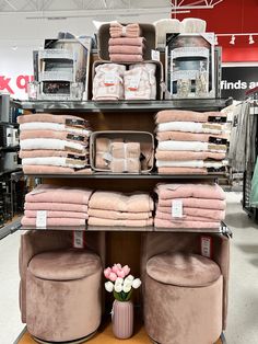 the shelves are full of towels and other items for sale in a store or showroom