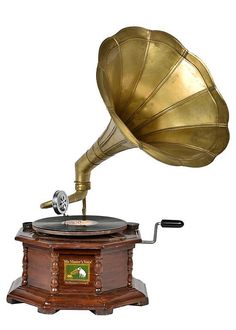 an old fashioned record player with a brass horn on top of it's stand