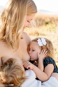 a mother and her two children cuddle together