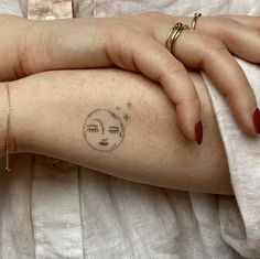 a woman's arm with a small tattoo on the left side of her arm