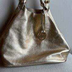 Michael Kors Bucket Bag. Reversible. Gold Metallic On One Side And Tan Suede On The Other. Never Been Used In Excellent Condition. Really Soft Subtle Leather. 13” Across Bottom, 11” From Bottom To Top Of Bag. 10” Drop On Strap. Bags Michael Kors, Gold Cream, Tan Suede, Cream And Gold, Michael Kors Bag, Bucket Bag, Gold Metal, Michael Kors, Bag Lady