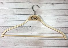 a wooden hanger with the word bye on it