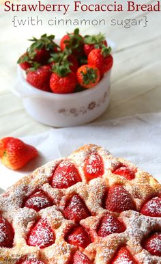 strawberry focaccia bread with cinnamon sugar on top and strawberries in the background