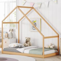 a child's bedroom with a wooden house bed and teddy bear on the floor