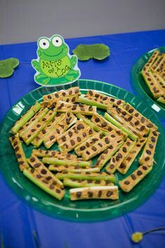 cheesy asparagus on a green plate with a frog cut out in the middle