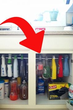 an open cabinet filled with cleaning products and condiments on top of a counter