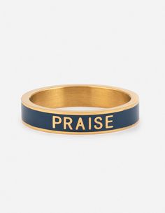 a gold and blue ring with the word praise written on it in black lettering, against a white background