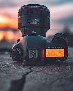 a camera sitting on the ground at sunset