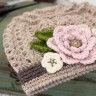 a crocheted hat with a flower on it