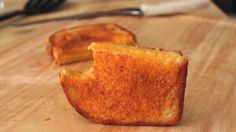 two pieces of toast sitting on top of a wooden cutting board