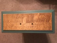 a wooden shelf with two holes in it