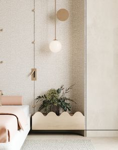 a bed sitting next to a plant in a room with white walls and flooring