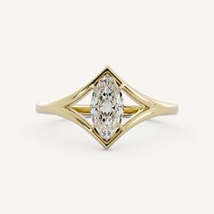 a yellow gold ring with an oval cut diamond in the center, on a white background